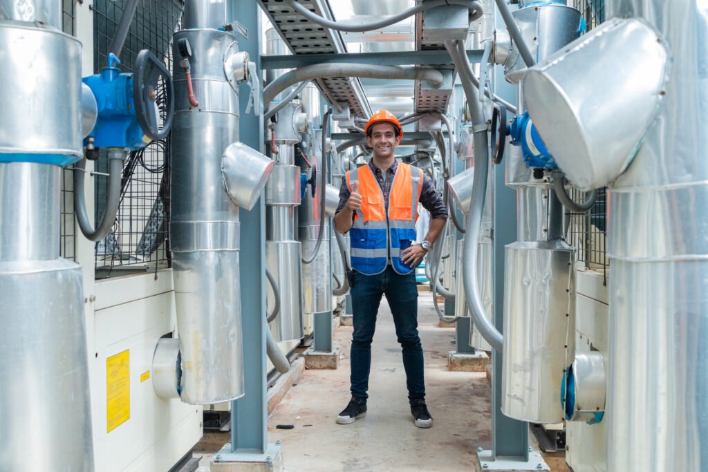 Engineers inspecting pneumatic conveying system in a modern powder handling plant