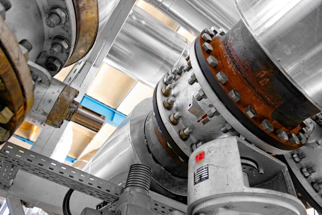 Close-up view of industrial pneumatic conveying pipeline showing precision engineering for pharmaceutical powder handling